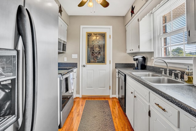 93 SW Ave, Buchanan, VA 24066 - kitchen with appliances with stainless steel finishes, a sink, a ceiling fan, white cabinets, and dark countertops