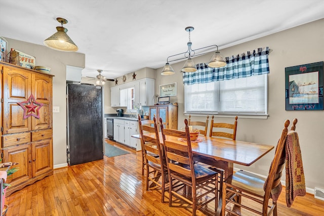 93 SW Ave, Buchanan, VA 24066 - dining room with a ceiling fan, light wood-style flooring, and baseboards