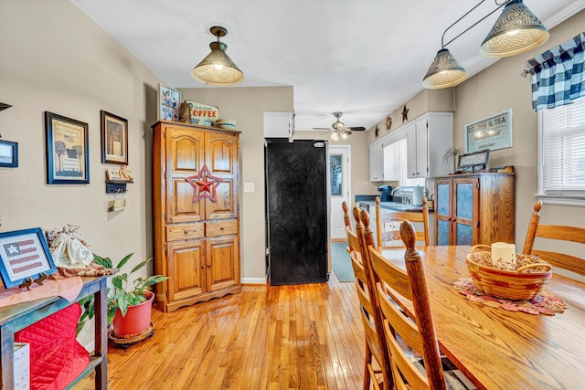 93 SW Ave, Buchanan, VA 24066 - dining room with light wood finished floors, a ceiling fan, and baseboards