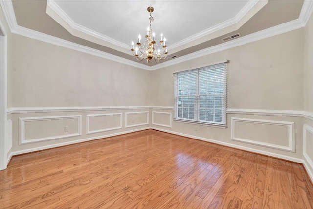 3326 Belshire Ct SW, Roanoke, VA 24014 - unfurnished room featuring a chandelier, a decorative wall, wood finished floors, crown molding, and a wainscoted wall