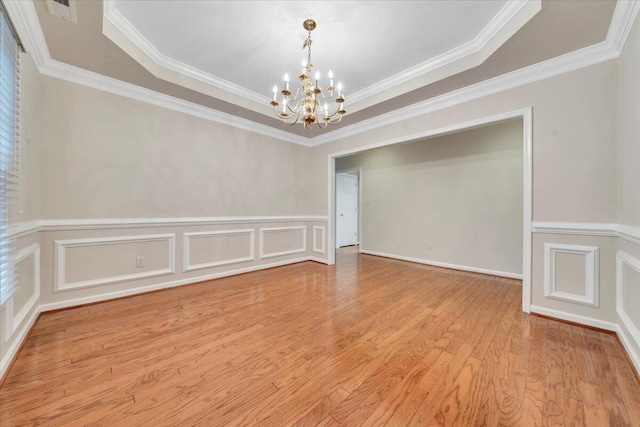 3326 Belshire Ct SW, Roanoke, VA 24014 - spare room featuring a chandelier, crown molding, wood finished floors, a raised ceiling, and a decorative wall