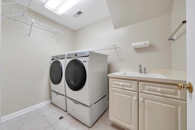 3326 Belshire Ct SW, Roanoke, VA 24014 - clothes washing area featuring washing machine and dryer, light tile patterned floors, baseboards, and cabinet space
