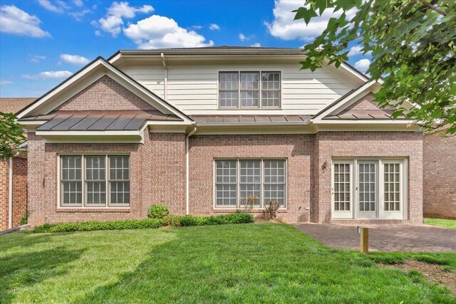3326 Belshire Ct SW, Roanoke, VA 24014 - rear view of house with a standing seam roof, brick siding, a lawn, and a patio
