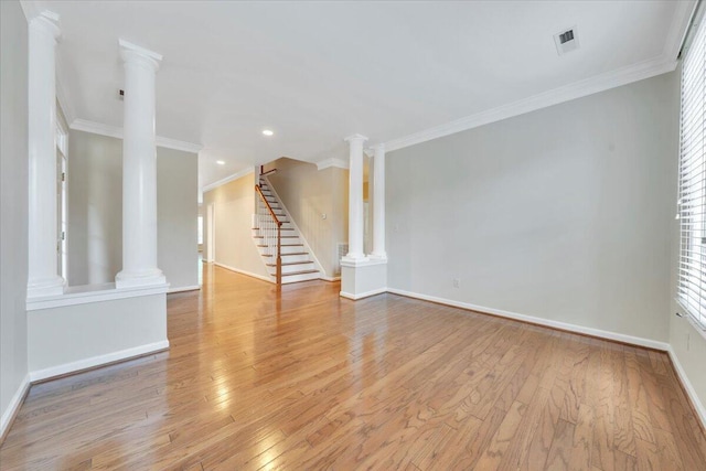 3326 Belshire Ct SW, Roanoke, VA 24014 - unfurnished living room featuring light wood-style flooring, ornamental molding, stairs, decorative columns, and baseboards