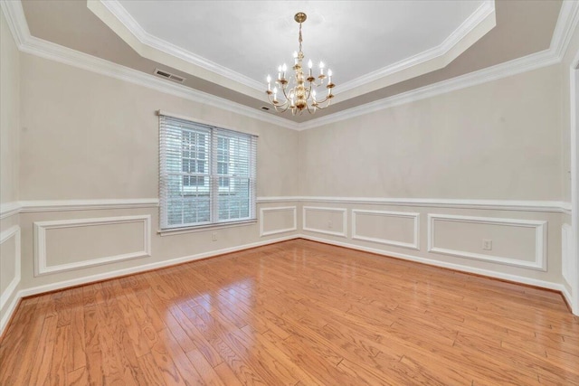 3326 Belshire Ct SW, Roanoke, VA 24014 - spare room with a chandelier, wood finished floors, ornamental molding, a decorative wall, and wainscoting