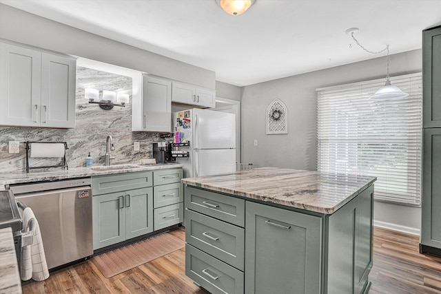 230 Pinehaven Rd, Fincastle, VA 24090 - kitchen with stainless steel dishwasher, freestanding refrigerator, a sink, decorative backsplash, and wood finished floors