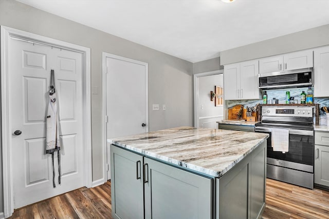 230 Pinehaven Rd, Fincastle, VA 24090 - kitchen with stainless steel appliances, wood finished floors, light stone counters, a center island, and gray cabinetry