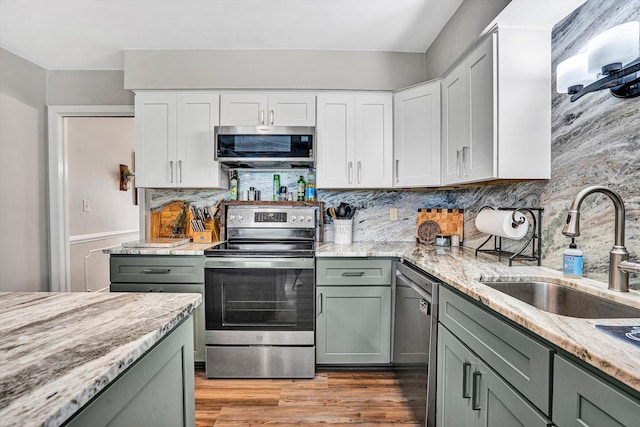 230 Pinehaven Rd, Fincastle, VA 24090 - kitchen with appliances with stainless steel finishes, a sink, light stone counters, light wood-style flooring, and gray cabinetry