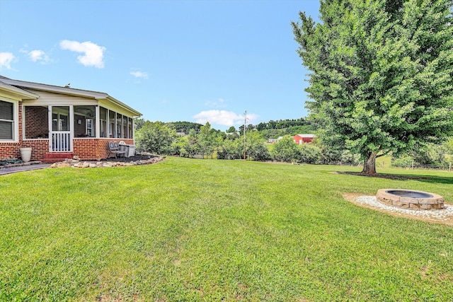 230 Pinehaven Rd, Fincastle, VA 24090 - view of green lawn with an outdoor fire pit and a sunroom
