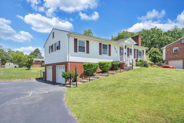 7073 Northway Dr, Roanoke, VA 24019 - view of front of home with a garage, driveway, a front lawn, a chimney, and brick siding