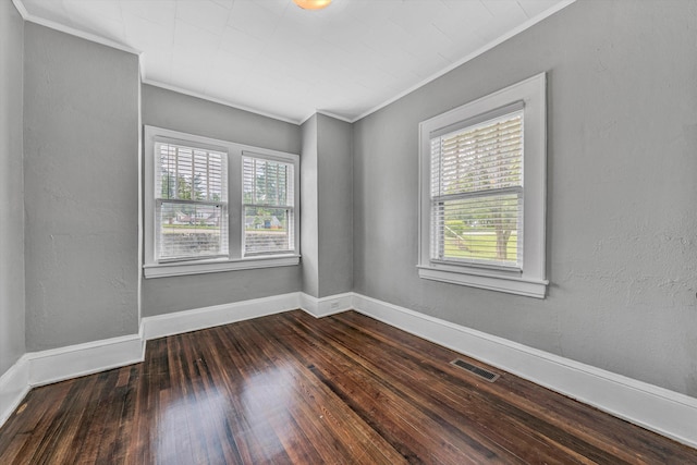 unfurnished room with crown molding, plenty of natural light, hardwood / wood-style floors, and baseboards