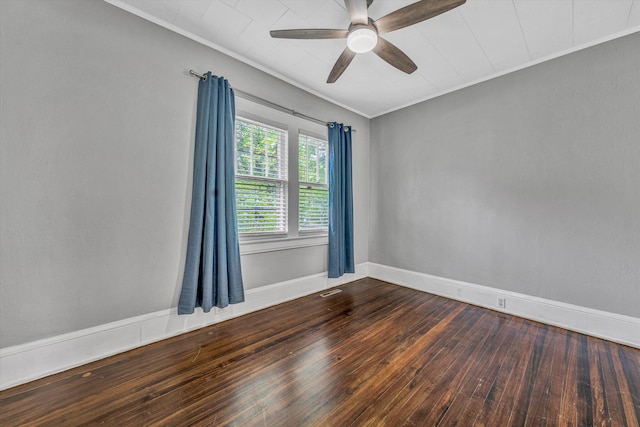 spare room with ceiling fan, dark wood-style flooring, crown molding, and baseboards