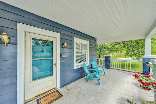 view of exterior entry with covered porch