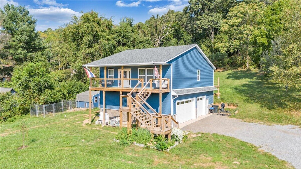908 E Dolly Ann Dr, Covington, VA 24426 - view of front of property with covered porch, a garage, driveway, stairs, and a wooded view