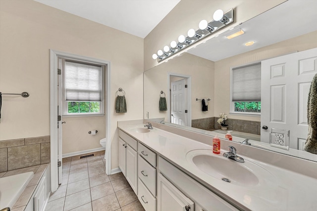 1309 W Pine Ridge Rd, Huddleston, VA 24104 - bathroom featuring toilet, tile patterned floors, a garden tub, double vanity, and baseboards