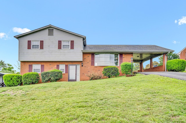 split level home featuring brick siding, a front lawn, and asphalt driveway