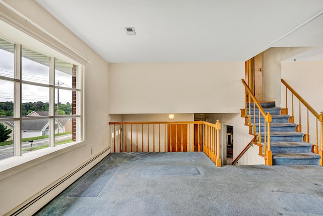 unfurnished room featuring a baseboard radiator and carpet
