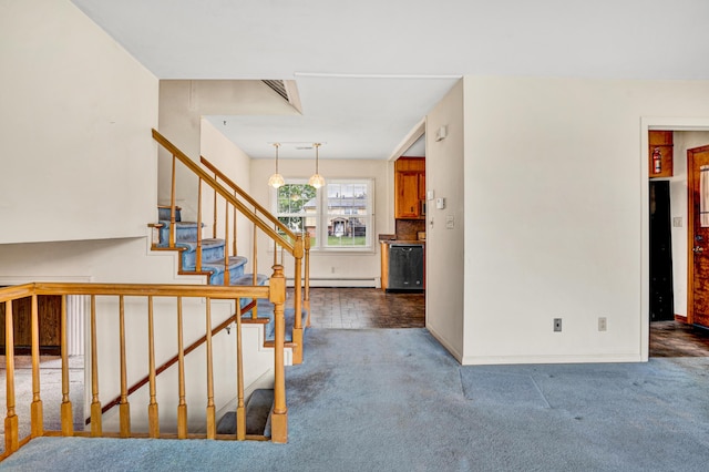 stairway featuring baseboard heating, carpet floors, and baseboards