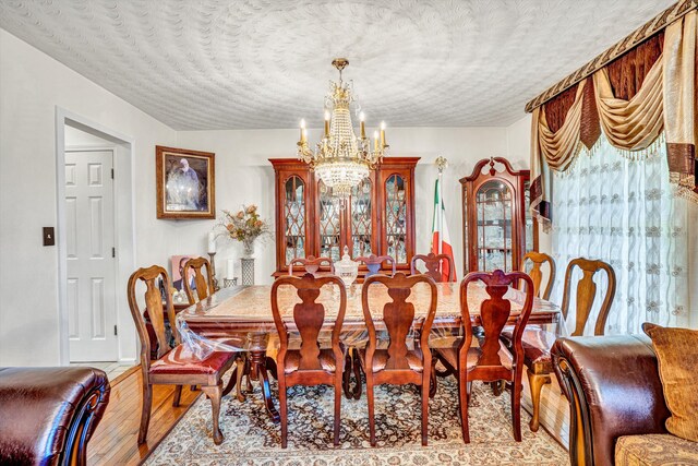 4434 Rosecrest Rd, Roanoke, VA 24018 - dining space featuring a chandelier, a textured ceiling, and wood finished floors