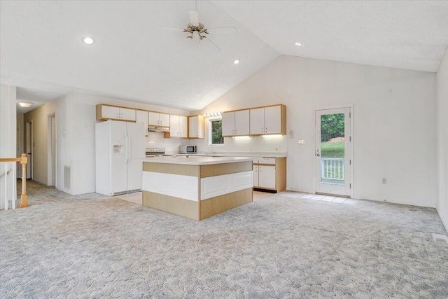 205 Park Shores Cir, Moneta, VA 24121 - kitchen with white refrigerator with ice dispenser, high vaulted ceiling, light colored carpet, electric stove, and a center island
