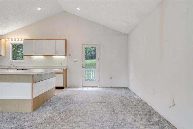 205 Park Shores Cir, Moneta, VA 24121 - kitchen with light colored carpet, light countertops, high vaulted ceiling, recessed lighting, and baseboards
