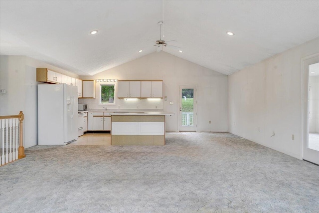 205 Park Shores Cir, Moneta, VA 24121 - kitchen with white appliances, ceiling fan, light countertops, light carpet, and lofted ceiling