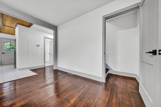 empty room with wood finished floors and baseboards