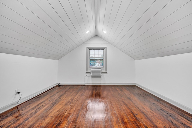 additional living space with vaulted ceiling, baseboards, hardwood / wood-style floors, wooden ceiling, and an AC wall unit