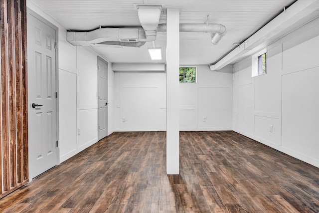 basement with plenty of natural light, wood finished floors, and baseboards