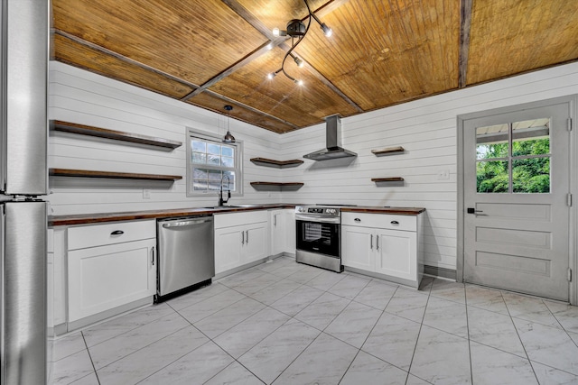 kitchen with open shelves, stainless steel appliances, wood ceiling, a sink, and wall chimney exhaust hood