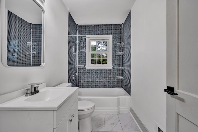bathroom featuring toilet, marble finish flooring, vanity, washtub / shower combination, and baseboards