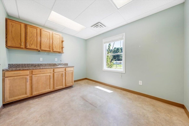8163 Floyd Hwy N, Copper Hill, VA 24079 - kitchen featuring a paneled ceiling, baseboards, a sink, and dark stone counters