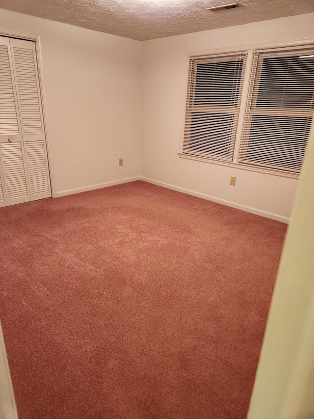 215 Overlook Rd, Vinton, VA 24179 - unfurnished bedroom with carpet flooring, a textured ceiling, a closet, and baseboards