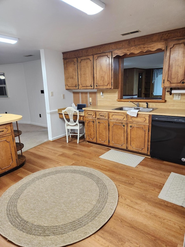 215 Overlook Rd, Vinton, VA 24179 - kitchen featuring black dishwasher, a sink, brown cabinets, light wood-style flooring, and light countertops