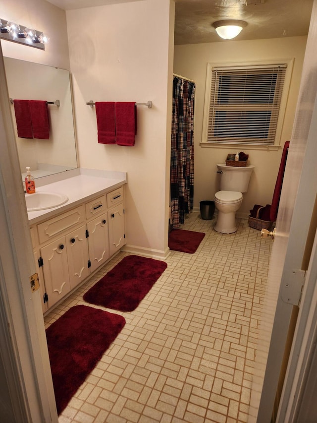 215 Overlook Rd, Vinton, VA 24179 - bathroom with toilet, vanity, baseboards, brick patterned flooring, and curtained shower
