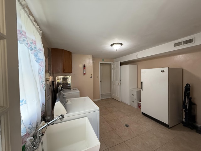 5265 Wipledale Ave, Roanoke, VA 24019 - laundry area with washing machine and dryer, light tile patterned flooring, and baseboards