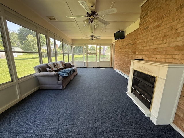 5265 Wipledale Ave, Roanoke, VA 24019 - sunroom with a ceiling fan, a glass covered fireplace, and a baseboard heating unit