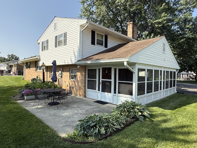 5265 Wipledale Ave, Roanoke, VA 24019 - back of property with a sunroom, a chimney, a yard, a patio, and brick siding