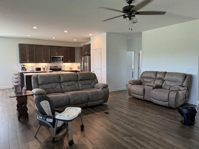 living room featuring dark wood-style floors, a ceiling fan, baseboards, and recessed lighting