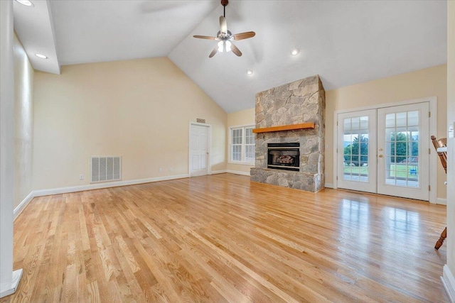 unfurnished living room with a ceiling fan, high vaulted ceiling, wood finished floors, baseboards, and recessed lighting