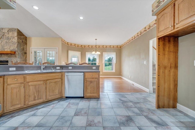 kitchen with stainless steel dishwasher, a sink, baseboards, a chandelier, and pendant lighting