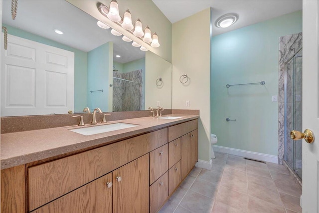 bathroom with a stall shower, toilet, tile patterned floors, baseboards, and double vanity