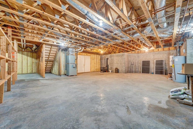 unfinished basement with water heater and heating unit