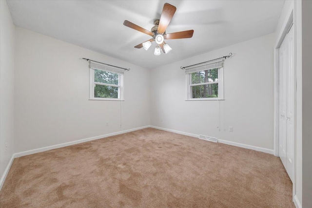 8209 Webster Dr, Roanoke, VA 24019 - unfurnished bedroom featuring a closet, light carpet, and multiple windows