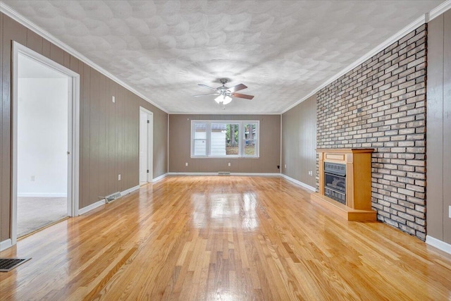 8209 Webster Dr, Roanoke, VA 24019 - unfurnished living room featuring a ceiling fan, light wood-type flooring, baseboards, a glass covered fireplace, and ornamental molding