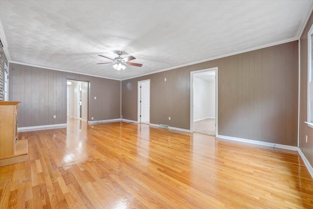 8209 Webster Dr, Roanoke, VA 24019 - spare room with a ceiling fan, light wood-style floors, crown molding, baseboards, and wood walls