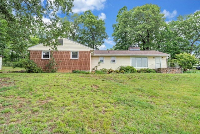 8209 Webster Dr, Roanoke, VA 24019 - back of house featuring a lawn, brick siding, and a chimney