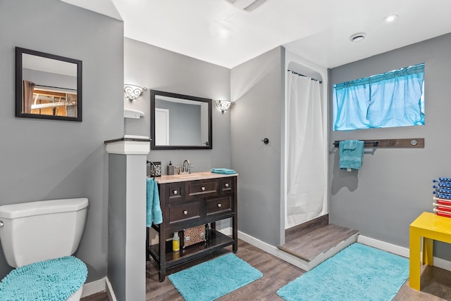 8574 Brubaker Dr, Roanoke, VA 24019 - full bathroom with wood finished floors, vanity, baseboards, and a shower with curtain