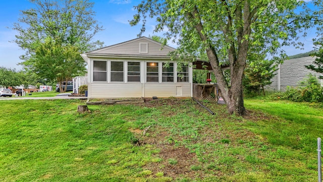 8574 Brubaker Dr, Roanoke, VA 24019 - back of house featuring a sunroom and a yard