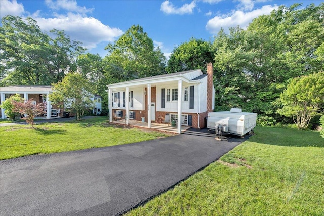 919 Halifax Cir, Vinton, VA 24179 - raised ranch featuring brick siding, covered porch, a chimney, and a front yard